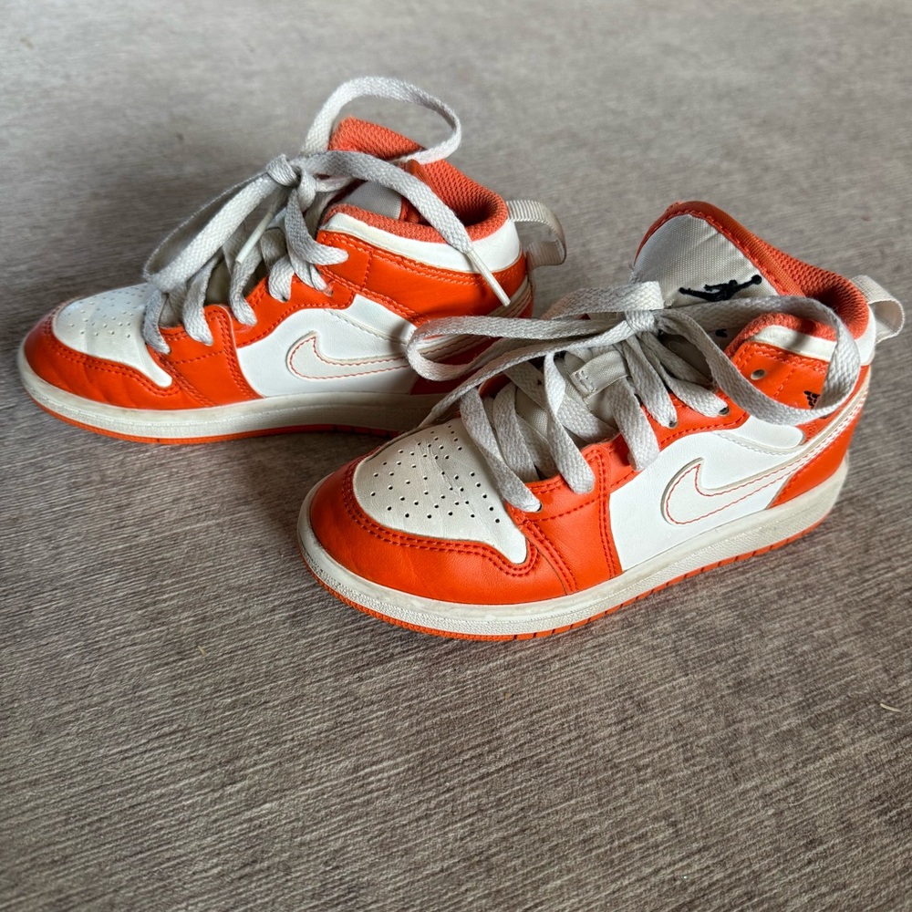 Kids Nike Air Jordan’s 11c orange and white sneakers